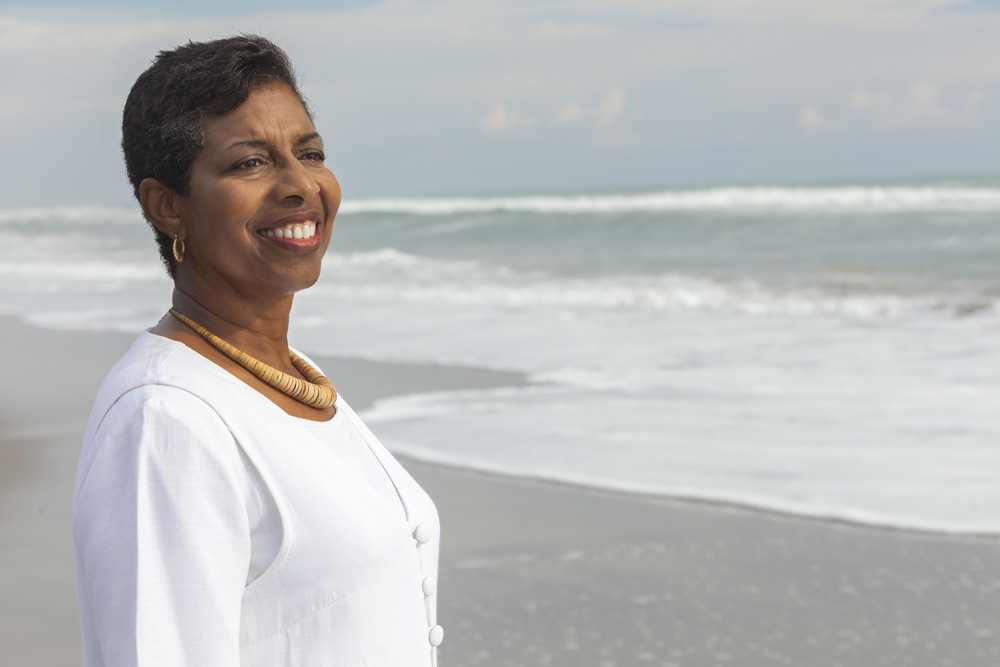 Smiling woman standing on the beach