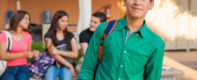 High school age students socializing and smiling